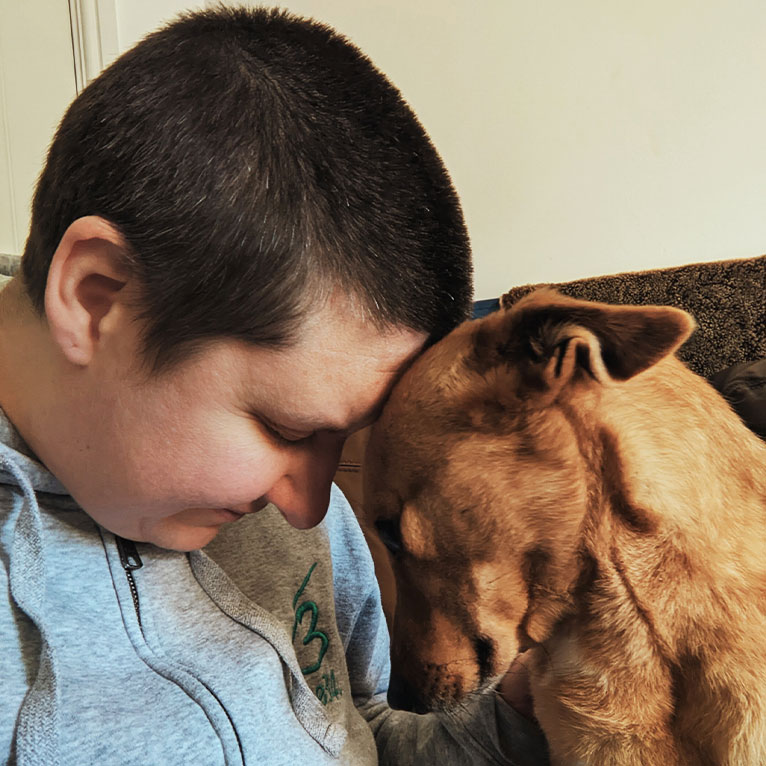 Liz Clifton cuddling a rescue dog.