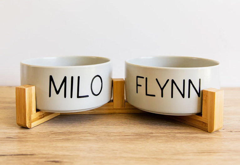 Personalised dog bowls with wooden support frame.