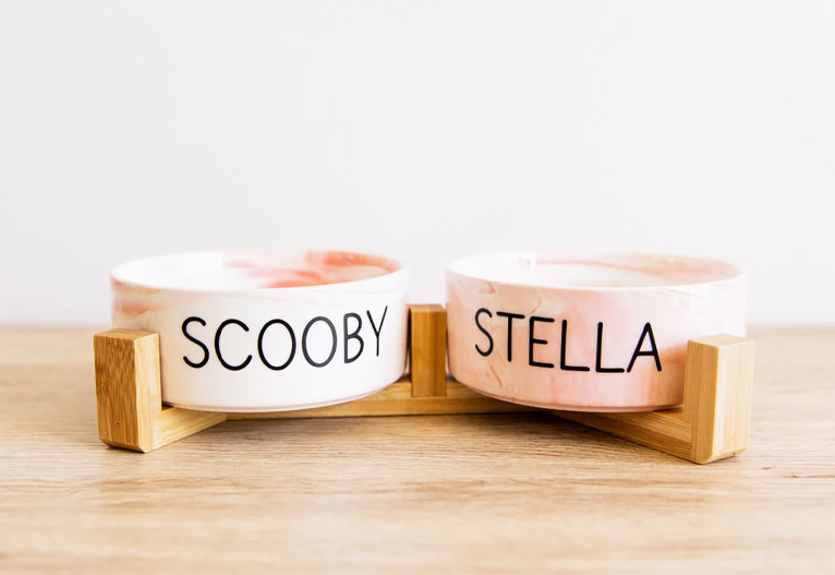 Personalised dog bowls with wooden support frame.